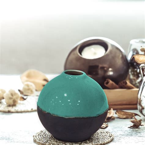 Out of these cookies, the cookies that are categorized as necessary are stored on your. Aqua green and black dual toned round ceramic vase ...