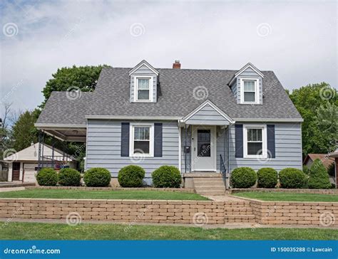 Little Blue Cape Cod House With Tan Brick Wall Stock Photo Image Of