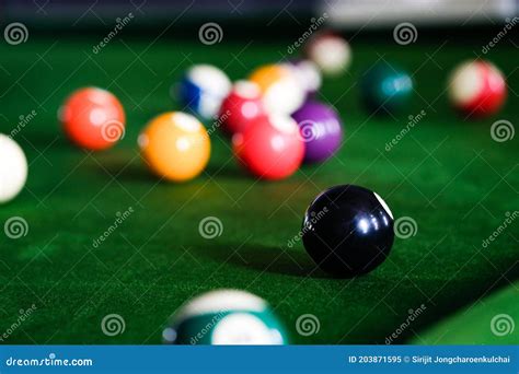 Man`s Hand And Cue Arm Playing Snooker Game Or Preparing Aiming To Shoot Pool Balls On A Green