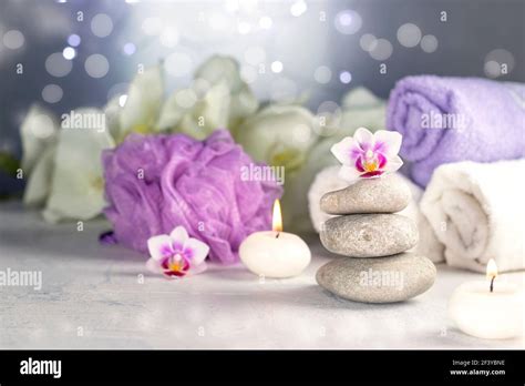 massage stones burning candles rolled towels flowers abstract lights spa resort therapy