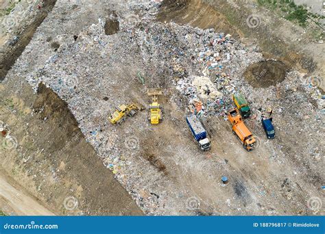 Garbage Pile In Trash Dump Or Landfill Dump Trucks And Excavators