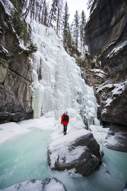 Hiker Exploring Frozen Maligne Canyon — One Person Cave Stock Photo