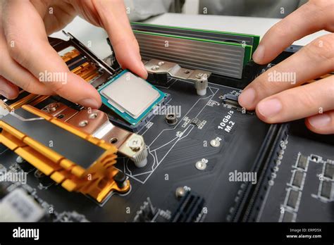 Hands Of A Technician Assembling Computer Hardware Parts As A New Cpu