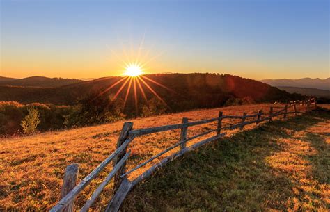 Grasslands Sunrises And Sunsets Fence Hill Rays Of Light Hd Wallpaper
