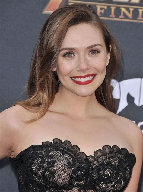 The Actress Is Smiling And Wearing A Black Dress With Lace Detailing On