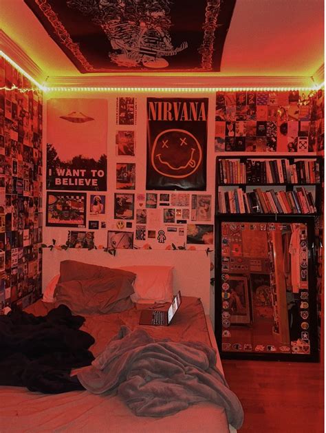 A Bedroom With Red Lights And Posters On The Wall Above The Bed Along