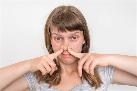 Young Woman Is Holding Her Nose Bad Smell Concept Stock Photo Image