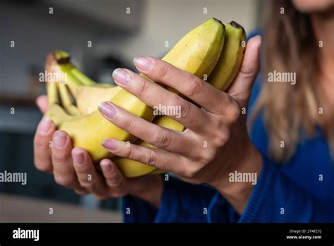 The Woman Holds Fruits In Her Hand The Girl Holds An Banana Bananas