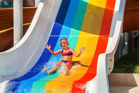 Child At Aquapark Slides Down The Water Slide Stock Photo Image Of