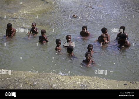 bathing in a river villagers bathing in a river in papua new guinea photographed in the
