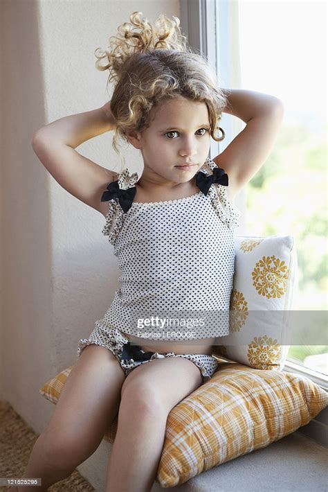 Cute Little Girl Sitting On The Window High Res Stock Photo Getty Images