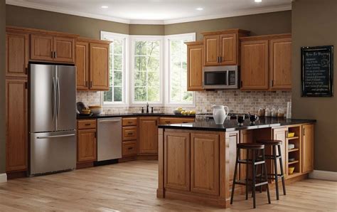 Your oak cabinets already have an aesthetically pleasing color, so all you have to do is to choose a certain laminate color for the flooring that can contrast the hue of the cabinets. Grey kitchen paint colors with oak cabinets - Decolover.net