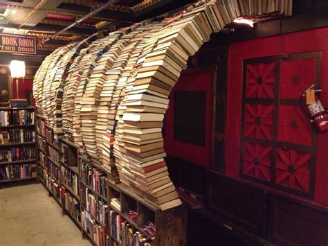 Many Books Are Stacked On Top Of Each Other In A Room Filled With Red Walls