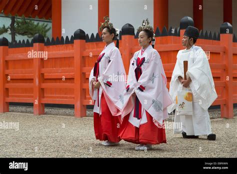 Shrine Maidens And Priest At Traditional Wedding Ceremony At Shinto