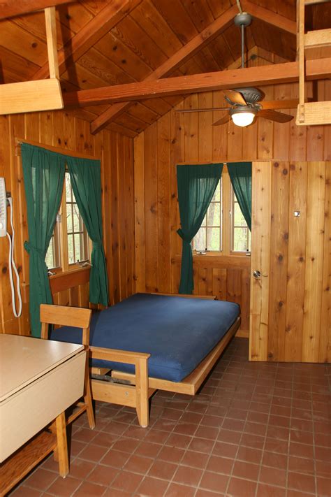 a bed in a room with wooden walls