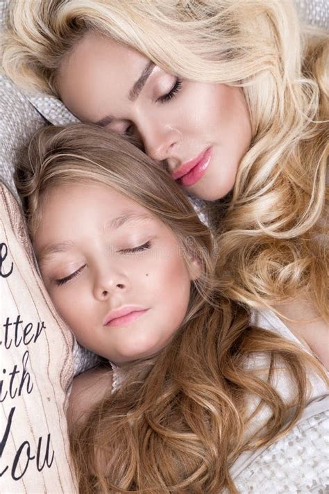 portrait of the beautiful blonde woman mother and daughter on the beautiful face and amazing