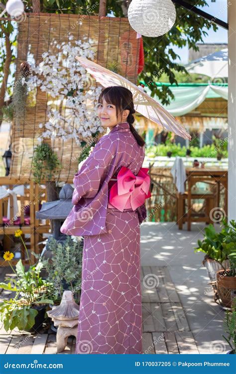The Girl Is Wearing A Pink Traditional Yukata Which Is The National