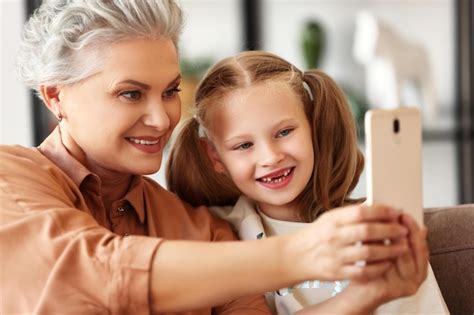 Premium Photo Happy Family Grandmother Smiling And Taking Selfie With Cheerful Girl