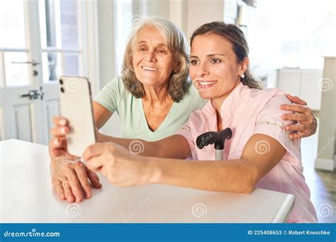 Mother And Daughter Streaming Video On Their Smartphone Stock Image Image Of Hold Eldercare