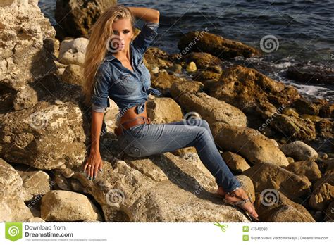 Pretty Girl With Long Blond Hair In Jeans Clothes Posing On Summer