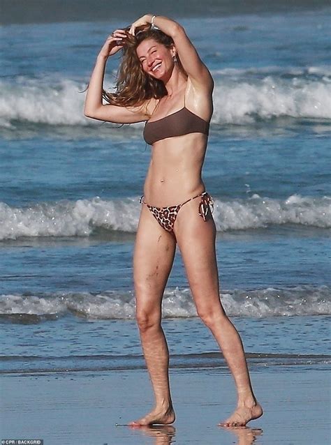 Giselle Puts Her Unreal Abs On Display While Frolicking Around The Beach In