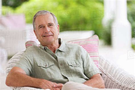 Older Man Sitting In Armchair Outdoors Stock Photo Dissolve