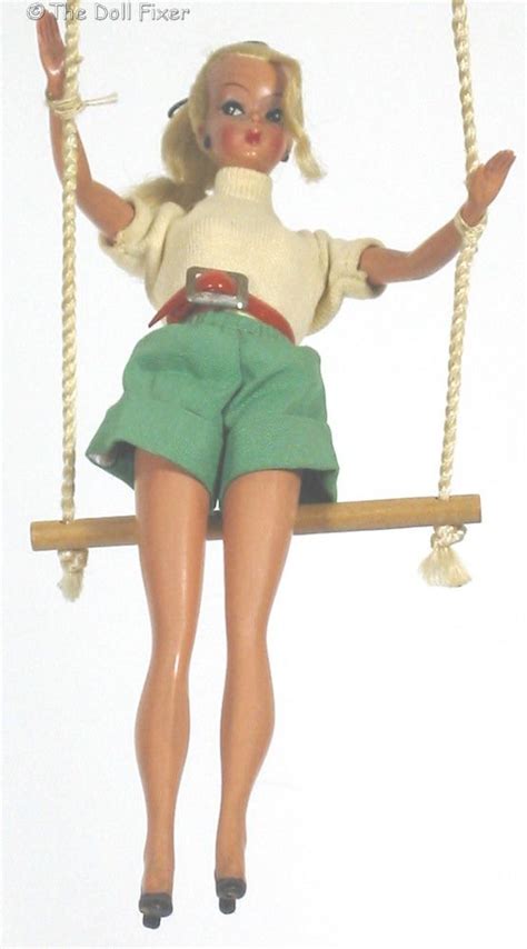 A Barbie Doll Is Sitting On A Swing