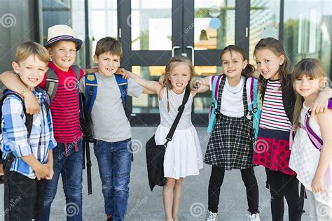 Portrait Of School Pupils Outside Classroom Carrying Bags Stock Image