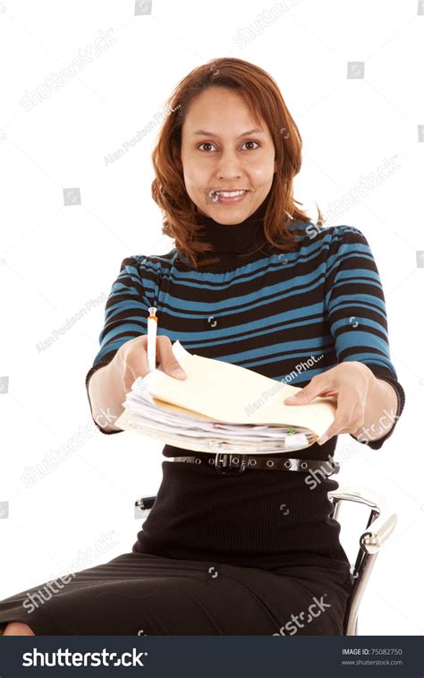 A Woman Is Sitting Handing Over A Folder Of Papers Stock Photo