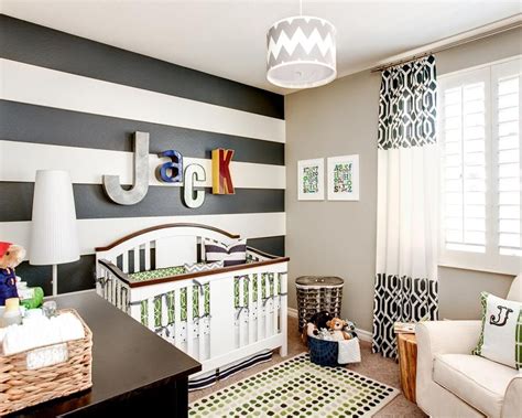 Black and white striped wall decor. A black and white striped accent wall showcases multicolored letters in this boy's nursery ...