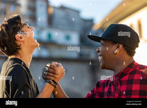 Two Young Men Sharing A Good Joke Laughing Together Stock Photo Alamy
