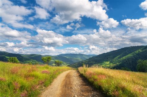 Mountain Dirt Road At Sunny Bright Day In Summer Landscape Stock Photo