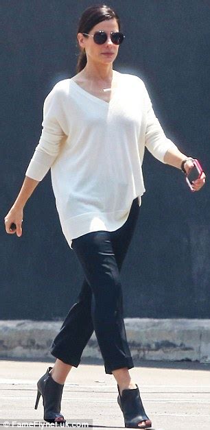 Sandra Bullock Glows In White V Neck Sweater And Cropped Trousers