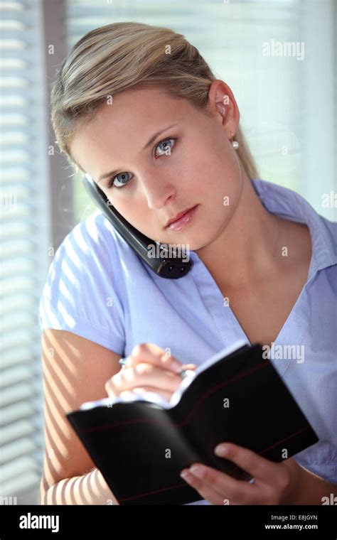 Blond Secretary Writing In Diary Stock Photo Alamy
