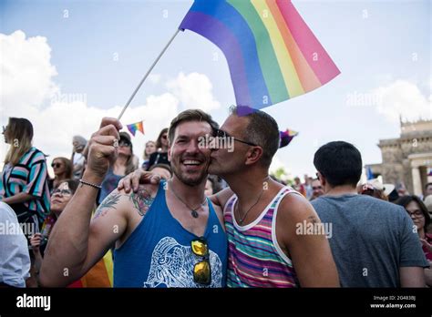 warsaw poland 19th june 2021 a gay couple seen kissing and waving the rainbow flag during