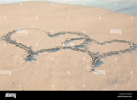 Two Hearts Drawn In The Sand Stock Photo Alamy