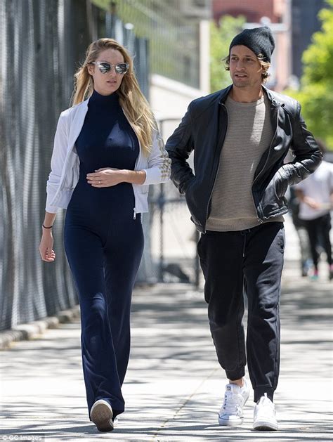 candice swanepoel shows off her bump in navy jumpsuit with fiancé hermann nicoli daily mail online
