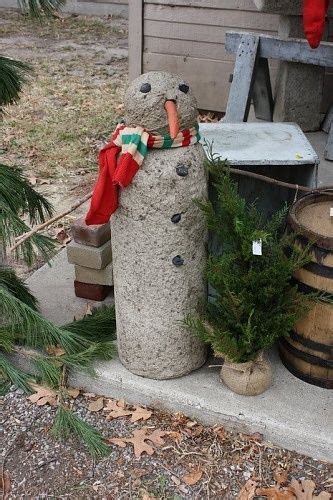 A Snowman Made Out Of Concrete Complete With A Carrot Nose And