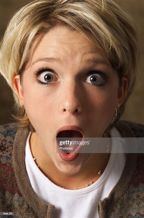 A Young Blond Caucasian Woman Has Her Eyes Wide As She Stares Open