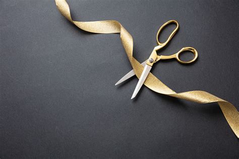 Grand Opening Gold Scissors Cutting Gold Satin Ribbon Black Background