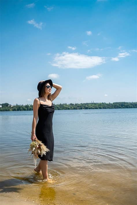 Barefoot Woman Walk In Pond In Black Dress Summer Day Stock Image