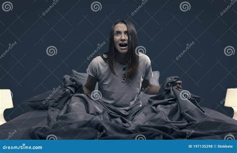 Woman Waking Up In Bed And Stopping An Alarm Clock Royalty Free Stock Photography