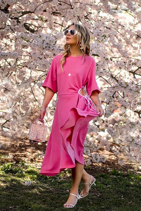 A Woman In A Pink Dress And Sunglasses