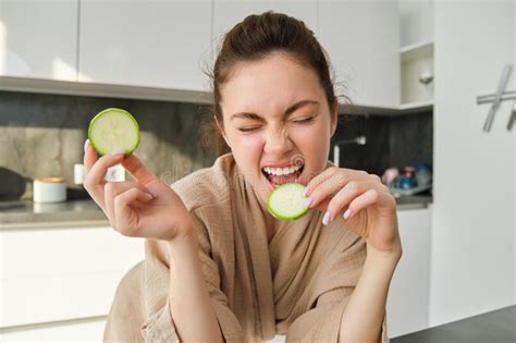Funny Happy Girl Eating Healthy Holding Zucchini Chopping Vegetables For Healthy Meal In The