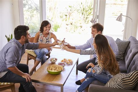 Couple Entertaining Friends At Home The Local Realty