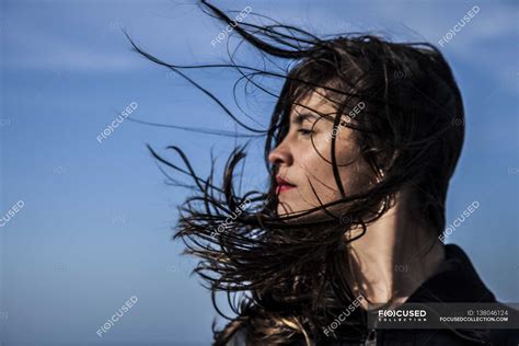 Young Woman With Hair Blowing On Wind — Caucasian Side View Stock