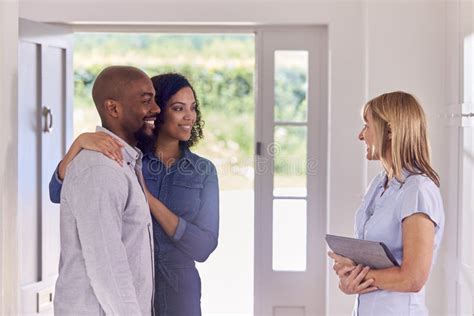 Couple Viewing Potential New Home With Female Realtor Stock Image Image Of Male Female 241032689