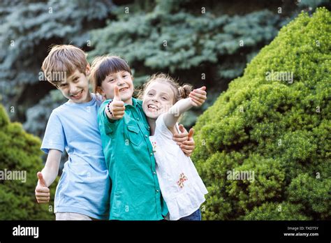 Group Of Happy Children Playing Outdoors Kids Having Fun In Summer