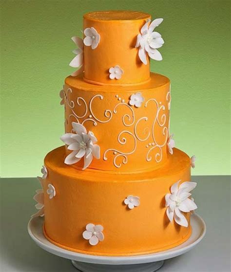 Three Tier Bright Orange Wedding Cake Covered With Orange Buttercream
