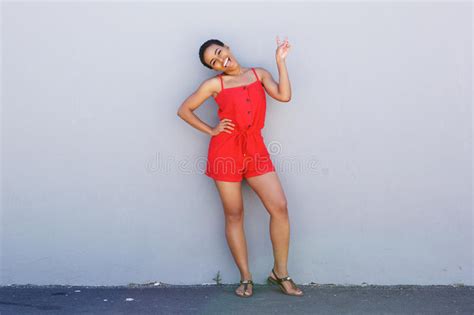 Full Body Beautiful Young Woman Laughing Against Gray Wall Stock Photos